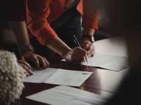 people signing a small business grant